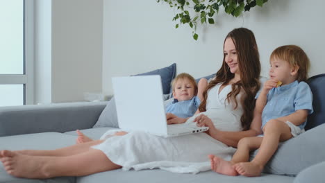 Happy-family-mother,-child-son-play-laptop-computer-at-home